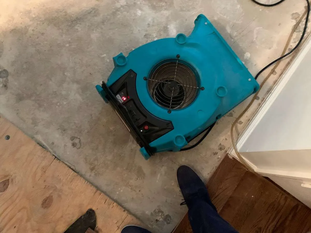 Air mover drying subfloor during Commercial Water Damage Restoration in Herriman